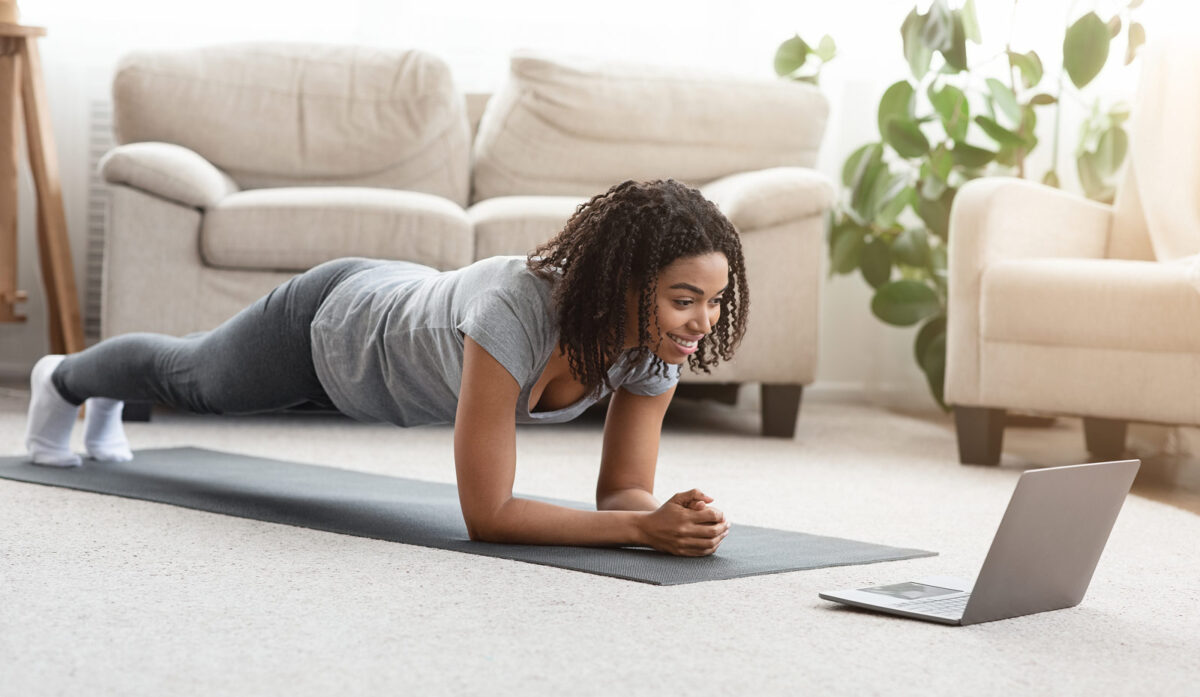 yoga woman in plank with online yoga class