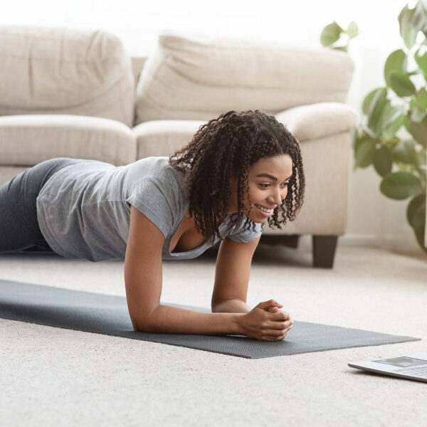 yoga woman in plank with online yoga class